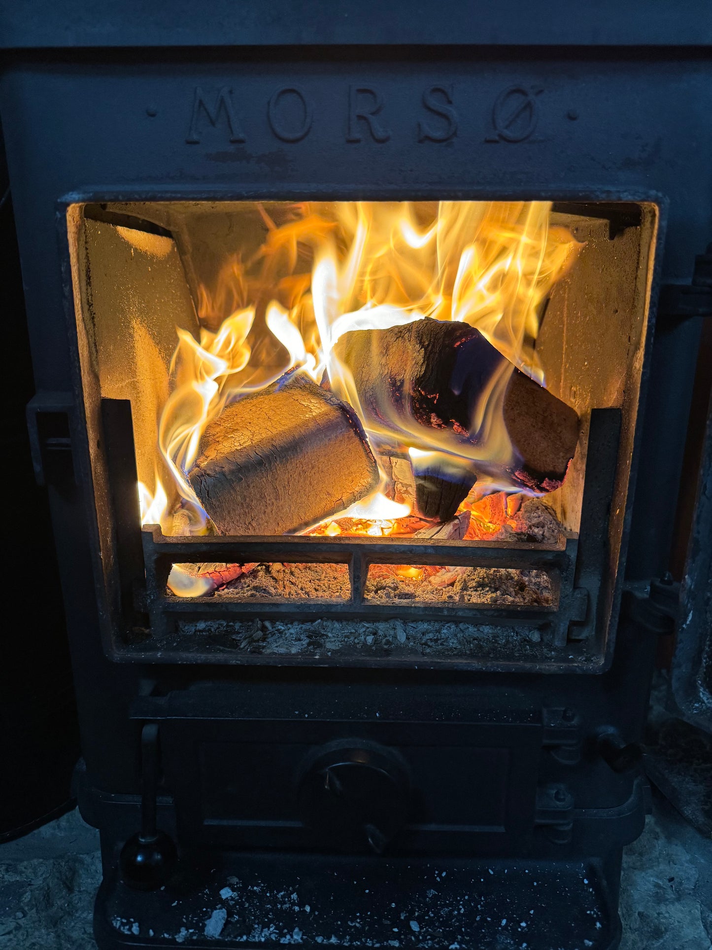 Log Burner with Burning Oko Sawdust Briquettes